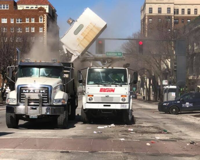 Parade clean-up-sweeper dumping into roll off