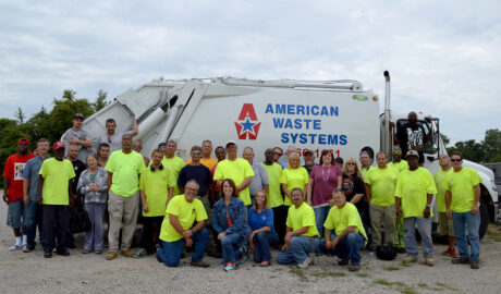 American Waste Systems staff in front of front loader truck